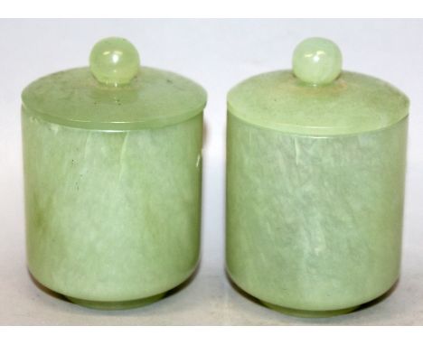A PAIR OF CHINESE CELADON GREEN JADE-LIKE JARS & COVERS, each 3.4in high overall.