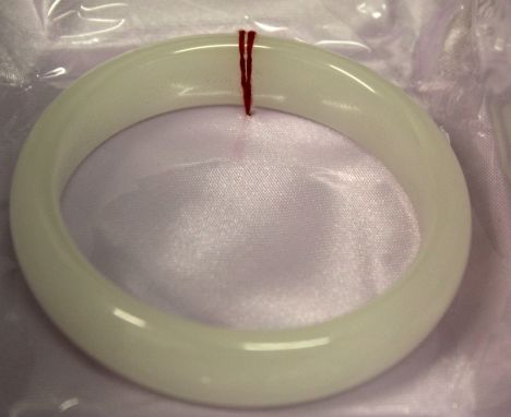 A CHINESE WHITE JADE BANGLE, 3.1in diameter, the inner rim 2.3in diameter.