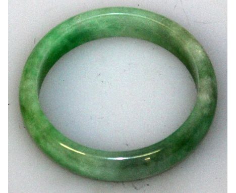 ANOTHER GOOD QUALITY GREEN JADE BANGLE, with paler inclusions, 2.75in diameter, the inner rim 2.1in diameter.