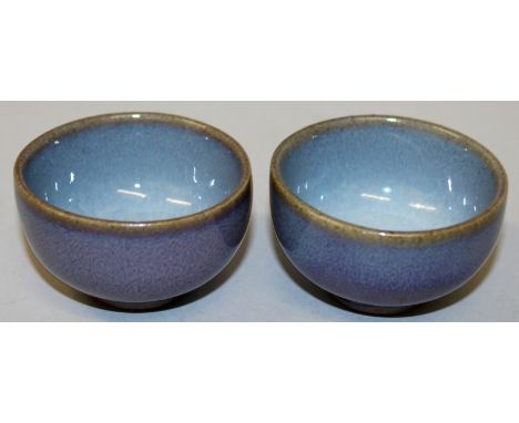 A PAIR OF CHINESE FLAMBE CERAMIC CUPS, each base unglazed, 2.3in diameter.