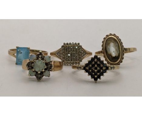 Five 9ct gold rings to include an opal and diamond flower head ring A/F, together with a 9ct and diamond ring and three other