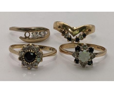 Three 9ct gold rings to include one set with a central opal, diamonds and sapphires, along with a yellow metal ring, total we