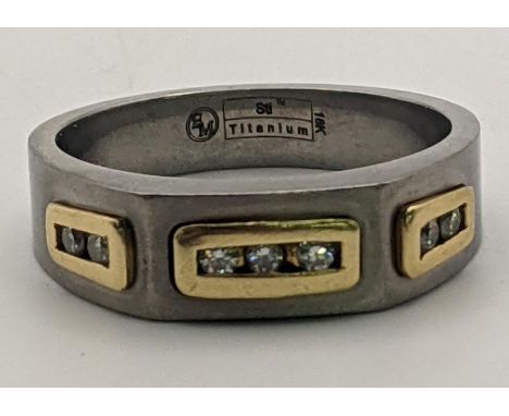 An 18ct gold and titanium gents ring set with seven diamonds 5.8g, size Y½Location: 
