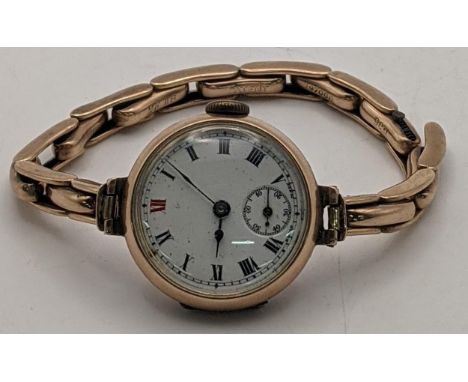 A ladies 9ct gold manual wind wristwatch on a 9ct gold expanding bracelet, A/F, total weight 21.1g, Location: 