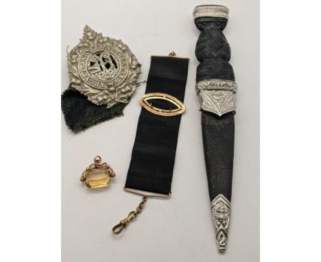 A Scottish Dubn/Dirk, an Argyll and Sutherland badge, and a gold plated chain with fabric panel and a 9ct gold and citrine fo