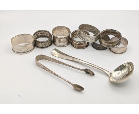 Mixed silver to include a silver sauce ladle, a variety of silver napkin rings, and a pair of sugar tongs, 219gLocation: 