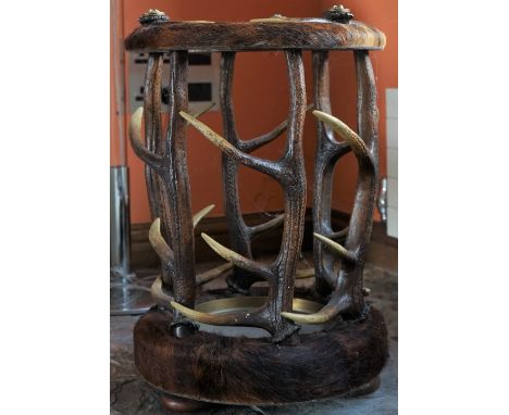 A hide and horn circular stick stand, 43cm diamter x 62cm high.