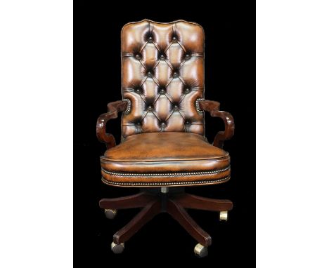 A modern hardwood framed office open armchair with brown button back leather upholstery, 61cm wide x 106cm high. 