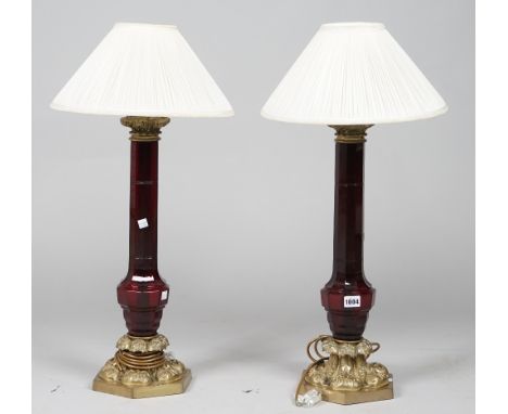 A pair of modern ruby glass and gilt metal table lamps, each of Victorian style on a hexagonal base, 55cm high, (2). 