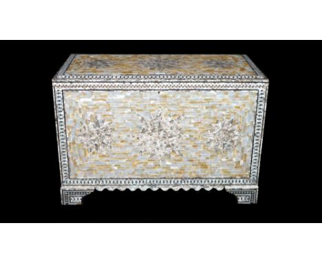 A modern mother-of-pearl decorated lift top trunk on bracket feet, 90cm wide x 61cm high. 