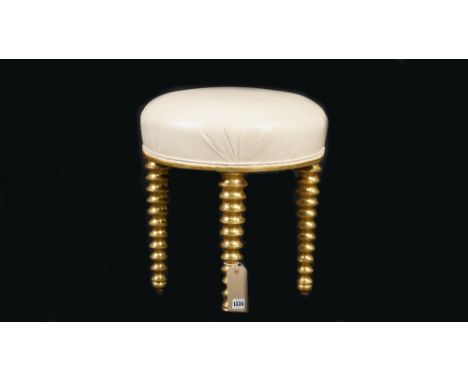 A modern giltwood circular footstool, on heavy bobbin turned supports, with faux white leather upholstery, 43cm diameter x 46