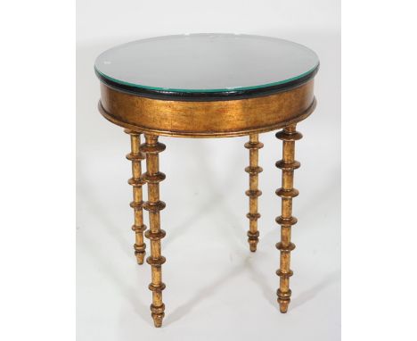 A modern giltwood circular occasional table, with ebonised elm top, on heavy bobbin turned supports, 60cm wide x 71cm high.