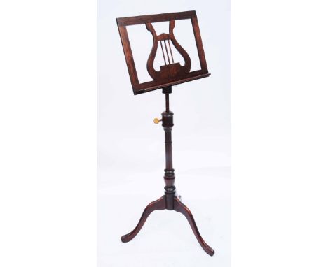 A GEORGE III STYLE MAHOGANY MUSIC STAND the height adjustable rest with swivel adjustment operated by a screw and pierced wit