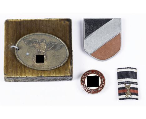 A Third Reich Geheimstaats Polizei ID tag; an SS tiepin; a Luftwaffe cap eagle; an NSDAP lapel badge; an Afrika Korps FS helm