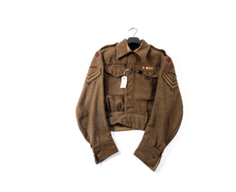 A WWII khaki battledress blouse, dated 1943, with corporals' stripes, printed cloth titles and coloured cloth flashes of the 