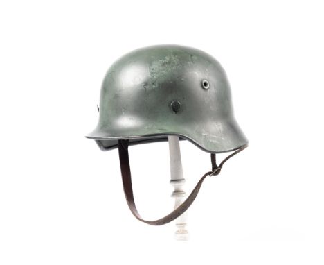 An M1936 Third Reich steel helmet, field grey finish (no decals), complete with lining and chinstrap. GC £140-150 