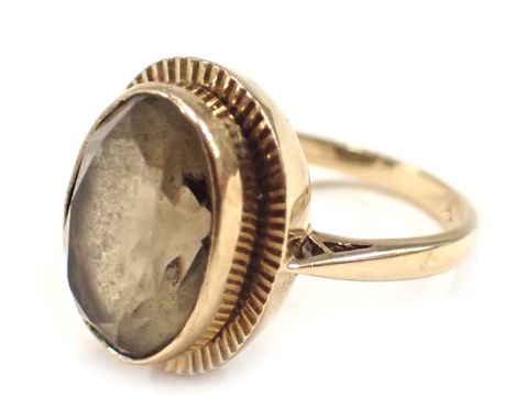 A 9ct gold dress ring, set with smoky quartz in rub over setting with star border, ring size N½, 5.1g all in.