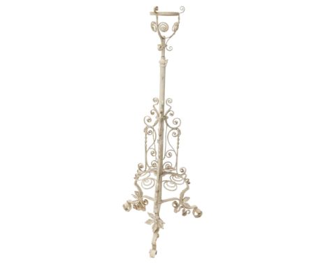 A late 19th/early 20thC wrought iron adjustable floor lamp, with fitting for an oil  lamp, later painted cream, on triform ba