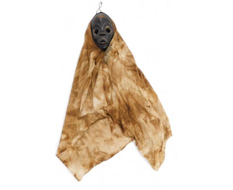 Tribal Art. 'Gunyege' running mask with long woven mudcloth hood/cloak, pressed metal around large round eyes, collected from