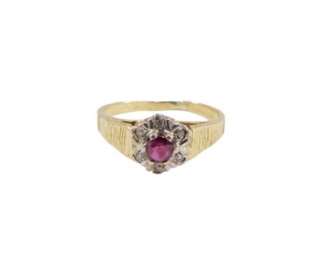 An 18ct gold ruby and diamond cluster ring, set with round brilliant cut ruby, in six claw setting, surrounded by tiny diamon