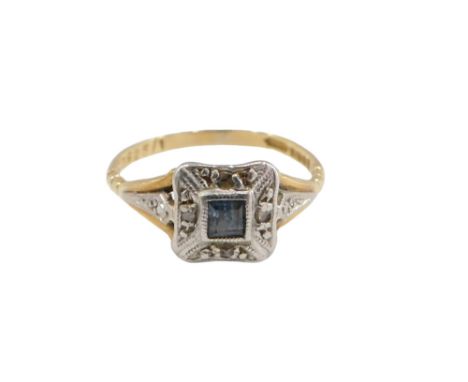 An 18ct gold sapphire and diamond Art Deco style dress ring, the square cut sapphire in rub over setting, surrounded by four 