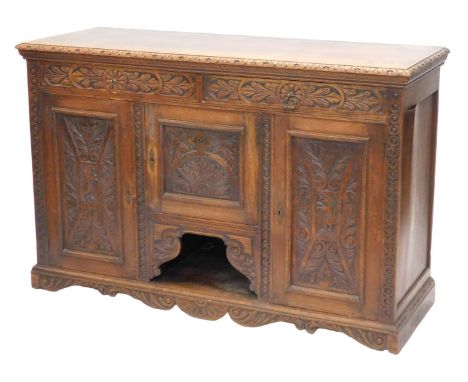 A late 19thC carved oak dresser, the rectangular top with a moulded edge, above two frieze drawers and an arrangement of thre