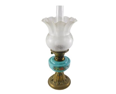 A Victorian oil lamp, with a frosted shade, decorated with flowers, the turquoise glass reservoir decorated with raised ename