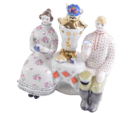 A USSR ceramic figure group of couple drinking tea, with blue K stamped to underside, 17cm high.