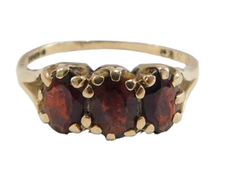 A 9ct gold garnet cluster ring, set with three oval garnets, each in claw setting, on V splayed shoulders, ring size L½, 1.8g