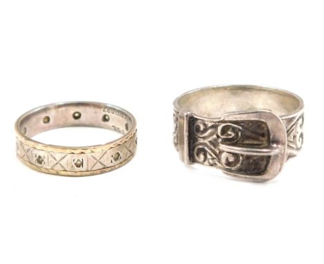 Two dress rings, comprising a 9ct gold and silver eternity ring, set with czs, ring size M½, and a silver buckle ring, ring s