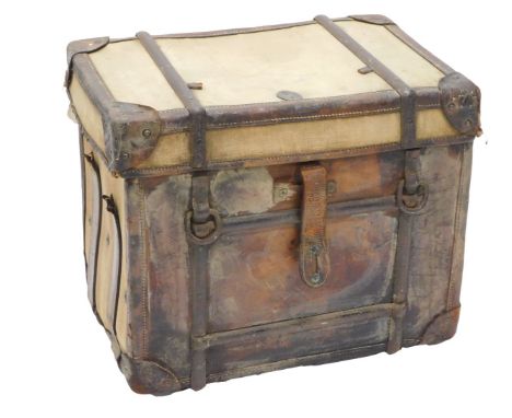 An early 20thC canvas and leather cabin trunk, with iron straps, 51cm high, 58cm wide. 