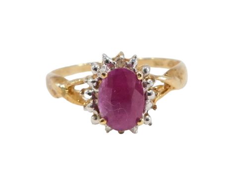 A dress ring, set with three dark red semi precious stones, comprising an oval central stone, in four claw setting, and two b