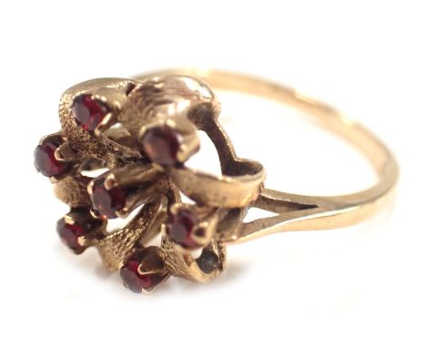 A 9ct gold cluster ring, the twist cluster set with arrangement of seven garnets, each in claw setting, ring size M½, 2.7g al