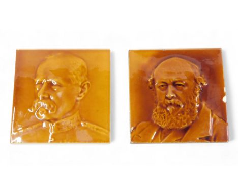 A J C Edwards Ruabon ceramic tile, modelled in the form of a military man, 15cm wide, and another similar. (2) 