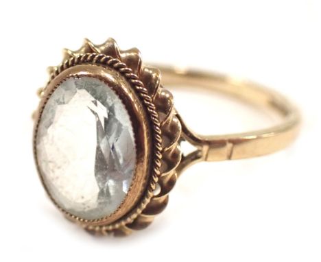 A 9ct gold dress ring, the oval aquamarine in rub over setting with rope twist border, on V splayed shoulders, ring size N½, 