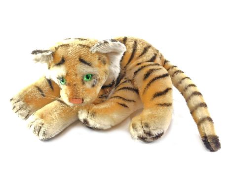 A Steiff plush tiger, 30cm long, ear stud detached. 