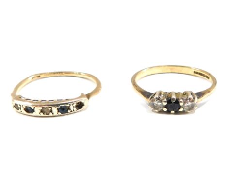 Two dress rings, comprising a 9ct gold blue and white paste stone set three cluster ring, ring size M½, and a panel ring set 