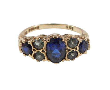 A sapphire and peridot gypsy ring, set with central oval sapphire flanked by two round brilliant cut peridots and two round b