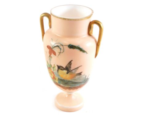 A Victorian opaque glass two handled vase, painted with birds and flowers, on a coral coloured ground, 25cm high. 