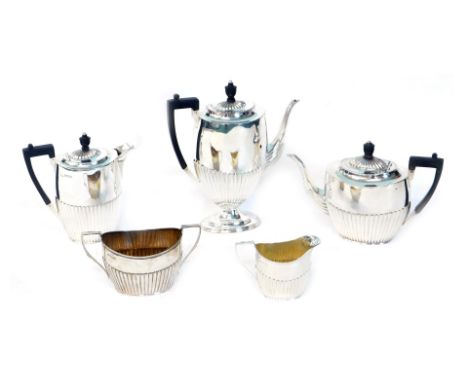 An Edwardian silver five piece tea and coffee set, of oval semi-fluted design, comprising tea pot, coffee pot, hot water jug,