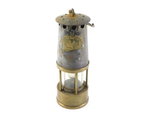 A Protector brass and steel miner's lamp, numbered 73, AF, 25cm high.