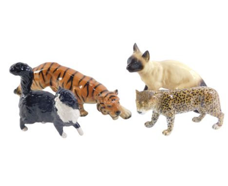 Four ceramic animal ornaments, comprising a Coopercraft Siamese cat, a tiger stamped Foreign, a USSR leopard, and a Royal Dou