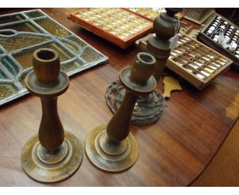 A pair of wooden candle stick and a wooden table lamp