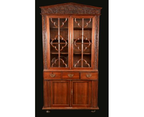 A 19th century Anglo-Chinese hardwood library bookcase, architectural pediment above a pair of glazed rectangular doors, the 
