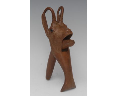 A Black Forest novelty lever-action nut cracker, carved as a goat, glass eyes, 22cm long, early 20th century
