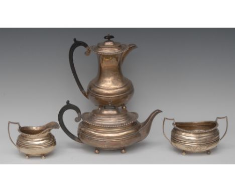 A George V silver four piece boat shaped tea service, comprising teapot, water jug, milk jug and two-handled sugar basin, gad