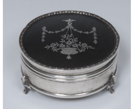 A George V silver and tortoiseshell pique circular dressing table trinket box, hinged cover inlaid in the Neo-Classical taste