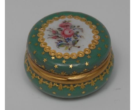 A late 19th century French circular green enamel bonbonnière, in the 18th century manner, the hinged cover centred by a flora