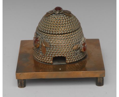 A Victorian novelty inkwell, by G.B. & Sons, cast as a bee skep, the rope twist hive applied with three cabachon-mounted bees