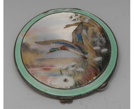 A George VI silver and enamel compact, hinged cover decorated in polychrome with a mallard taking to flight, within a green e